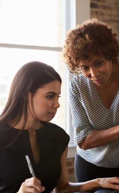 Woman listening and learning from a mentor